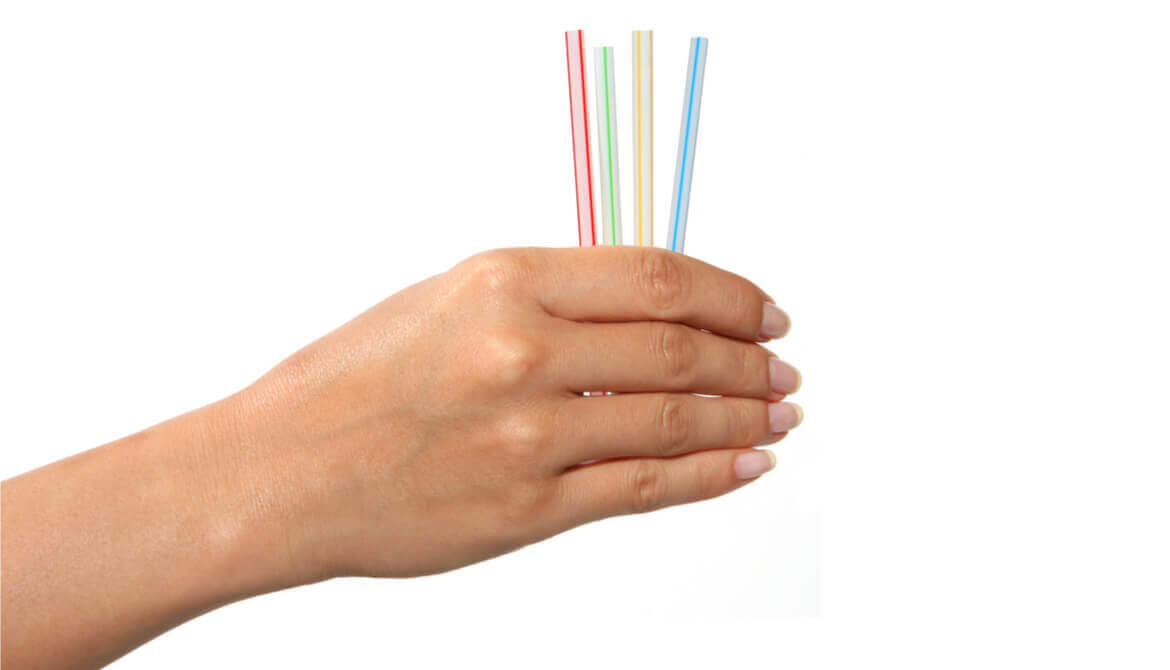 hand holds a collection of colorful straws