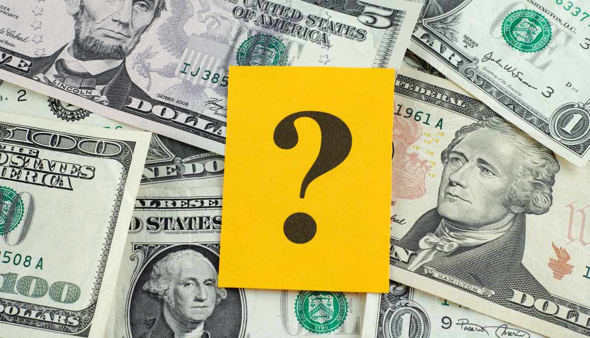 question mark over dollar bills