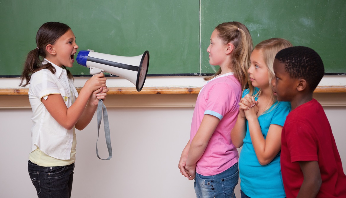 Young girl yelling orders through megaphone at classmates