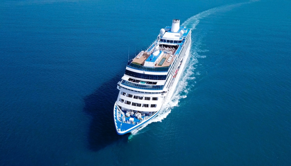 giant cruise ship sailing through blue sea