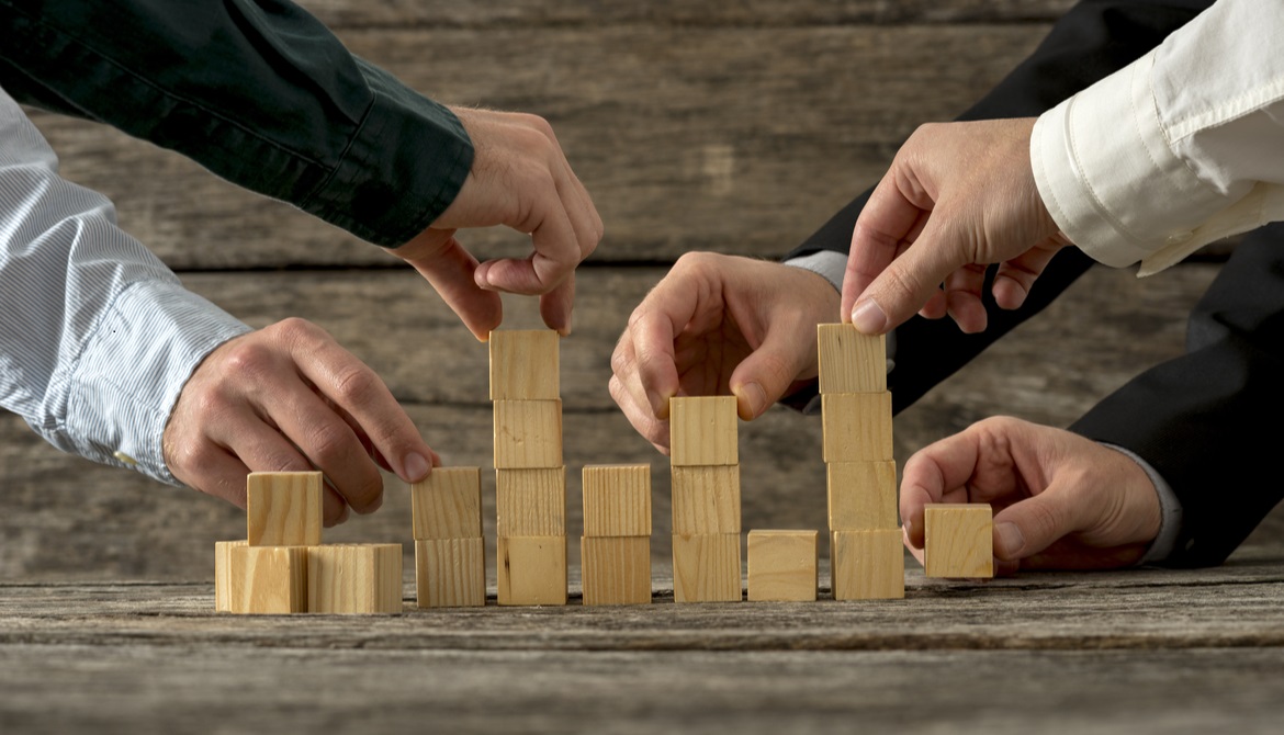executives stacking wooden blocks