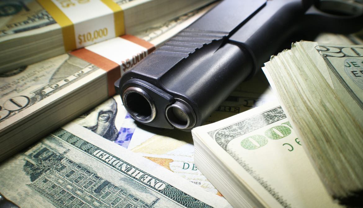 gun on top of money