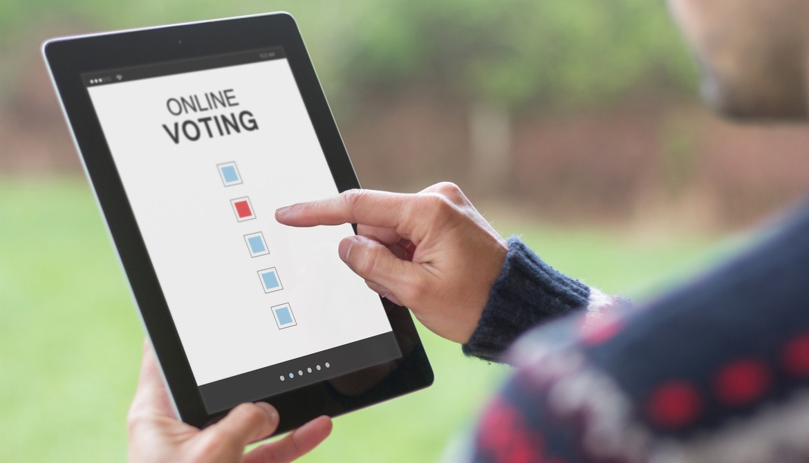 man using digital tablet to vote online