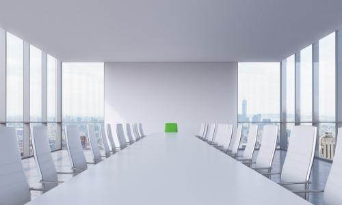 White modern conference room with a green chair in a head of the table