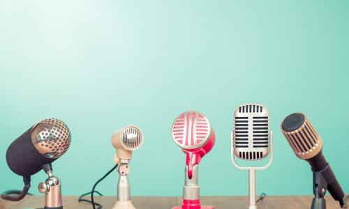 old style microphones on a mint green background