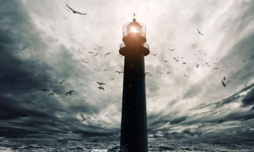 lighthouse shining over stormy seas