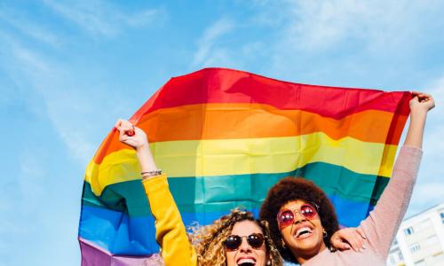 two women fly pride flag
