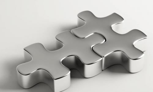 silver metallic puzzle pieces interlock