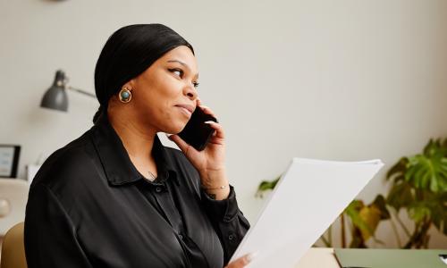 black woman using smartphone in office