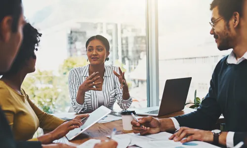 coworkers sitting around a table working together