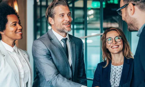group of people with 2 gentlemen shaking hands