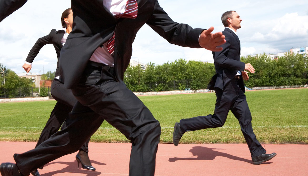 businesspeople racing and keeping pace around a track