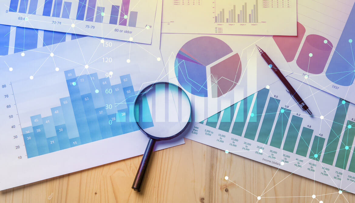 Magnifying glass with papers with data