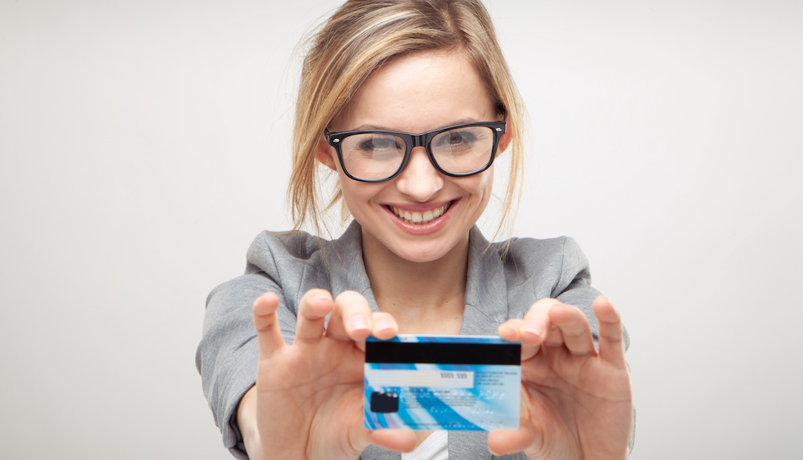 happy young business woman holding a new credit or debit card