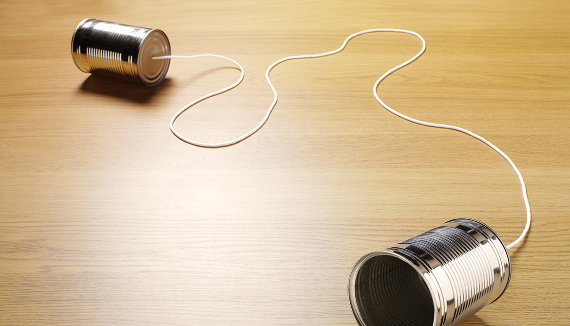 two tin cans joined by string showing communication