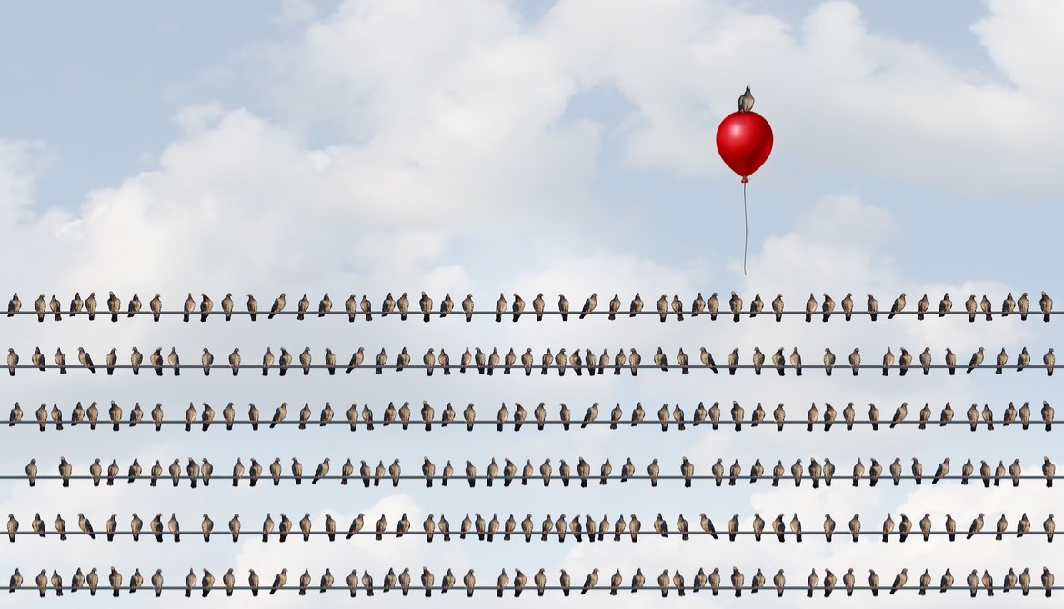 birds on a wire with one rising above the crowd on a red balloon