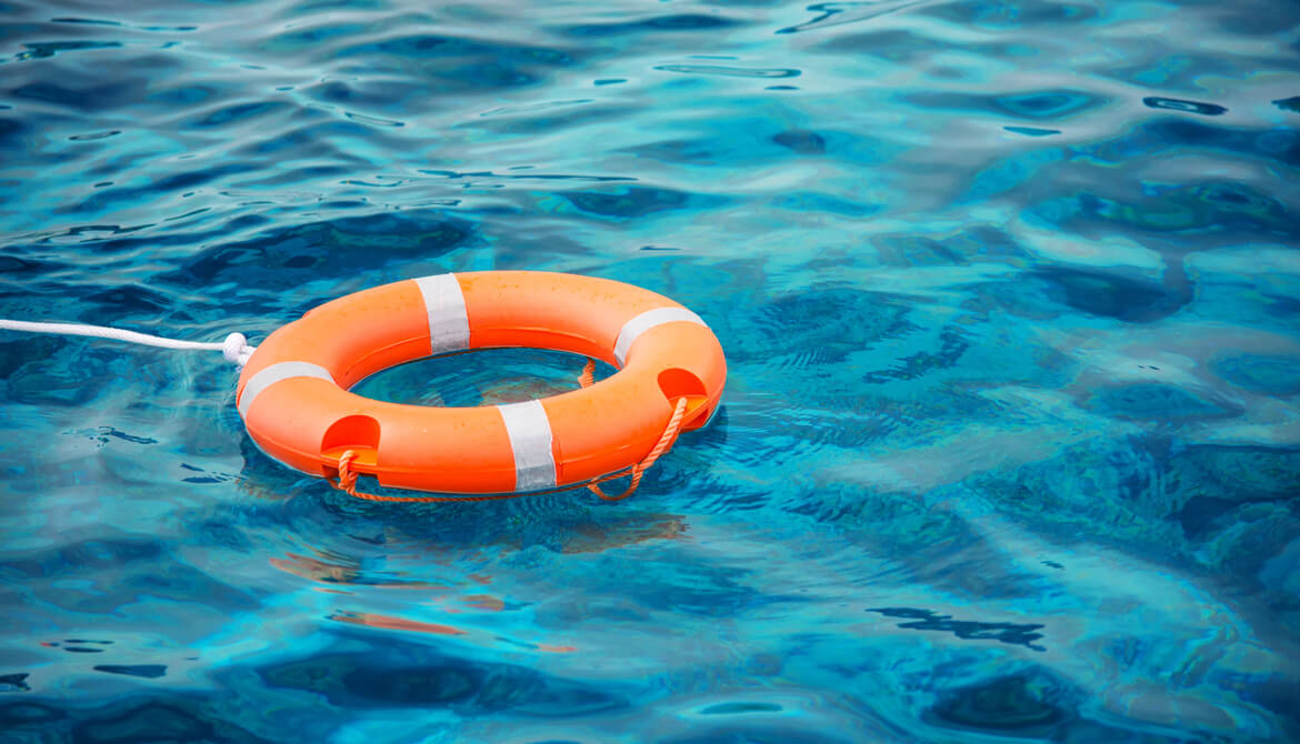 A life preserver ring made out of $100 bills, floating in the water