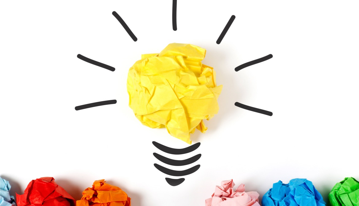 colorful crumpled paper transforms into idea lightbulb