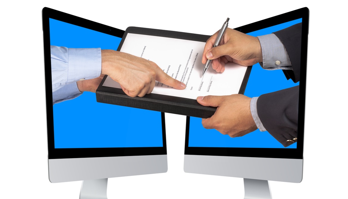 hands coming out of computers taking an e-signature on a contract