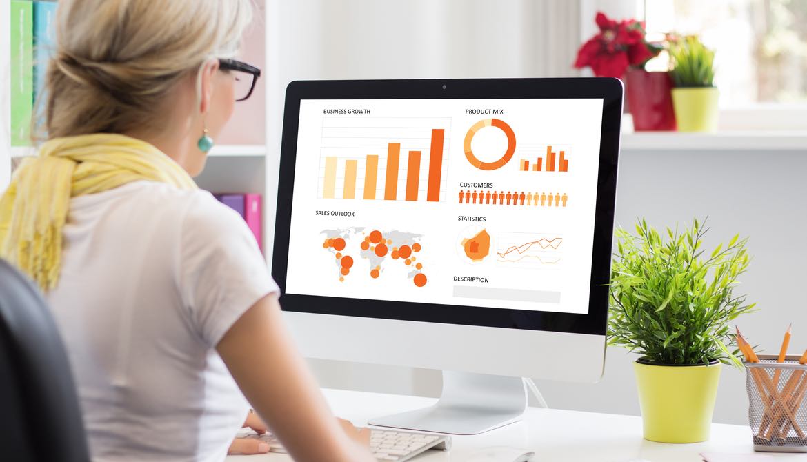 woman looking at a visualization of data on her computer screen