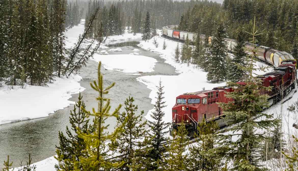 freight train rounding curve in the snow