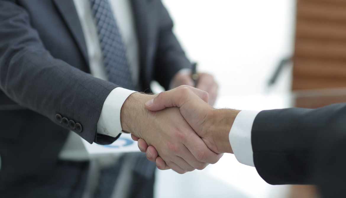 shaking hands with newly hired or promoted executive