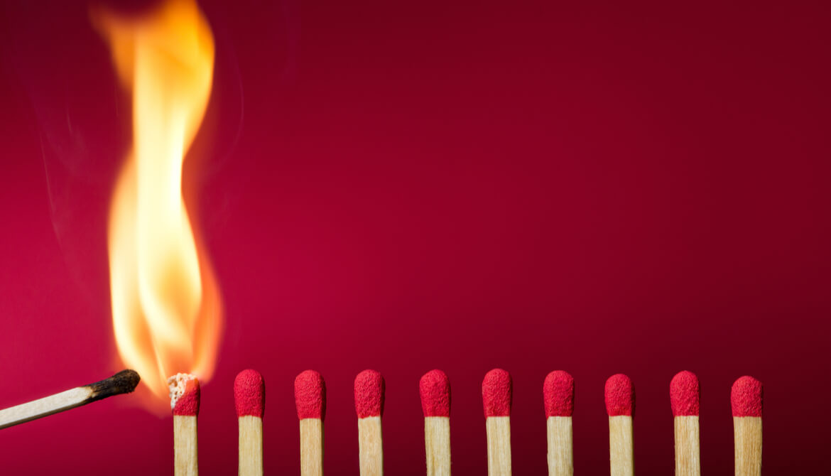 igniting a row of matches on red background