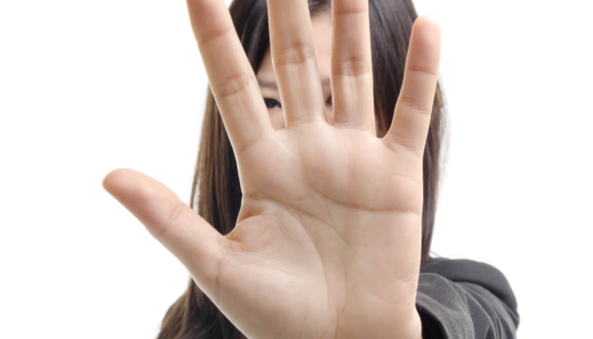 Businesswoman holding up her hand in a strong stop gesture