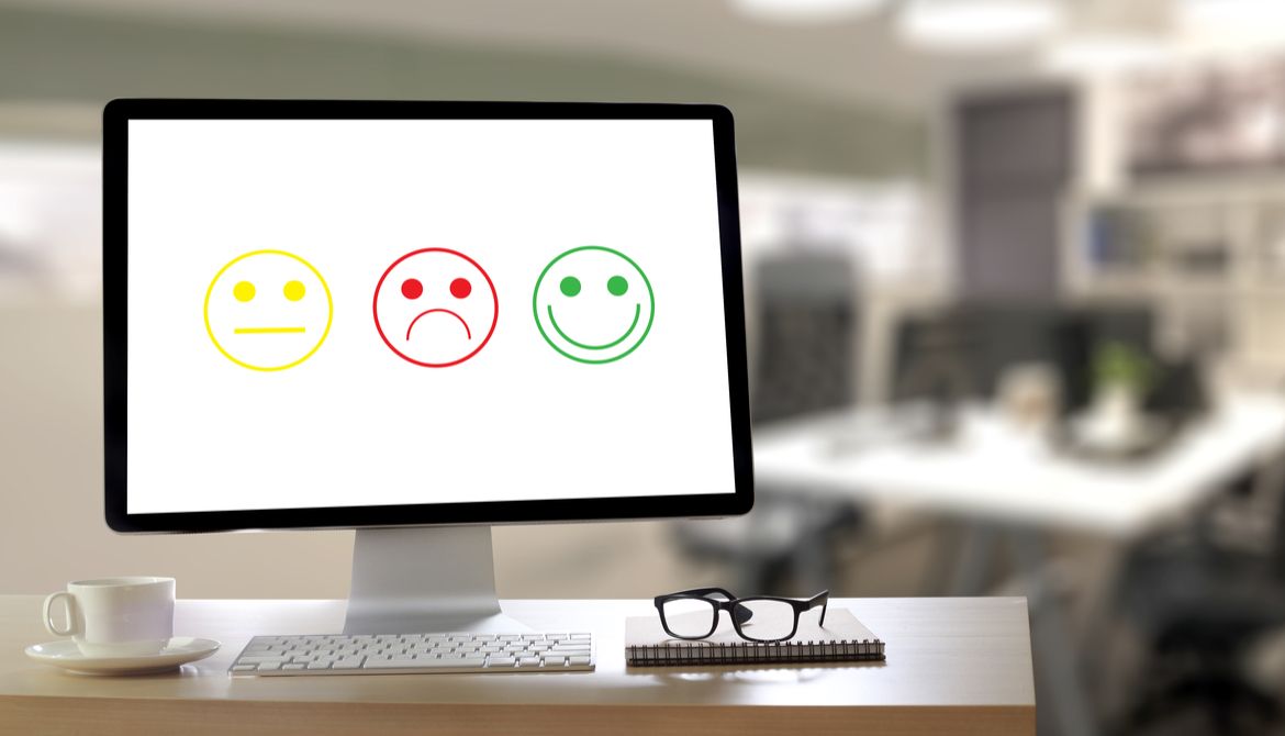 computer displaying yellow neutral green happy and red sad smiley faces