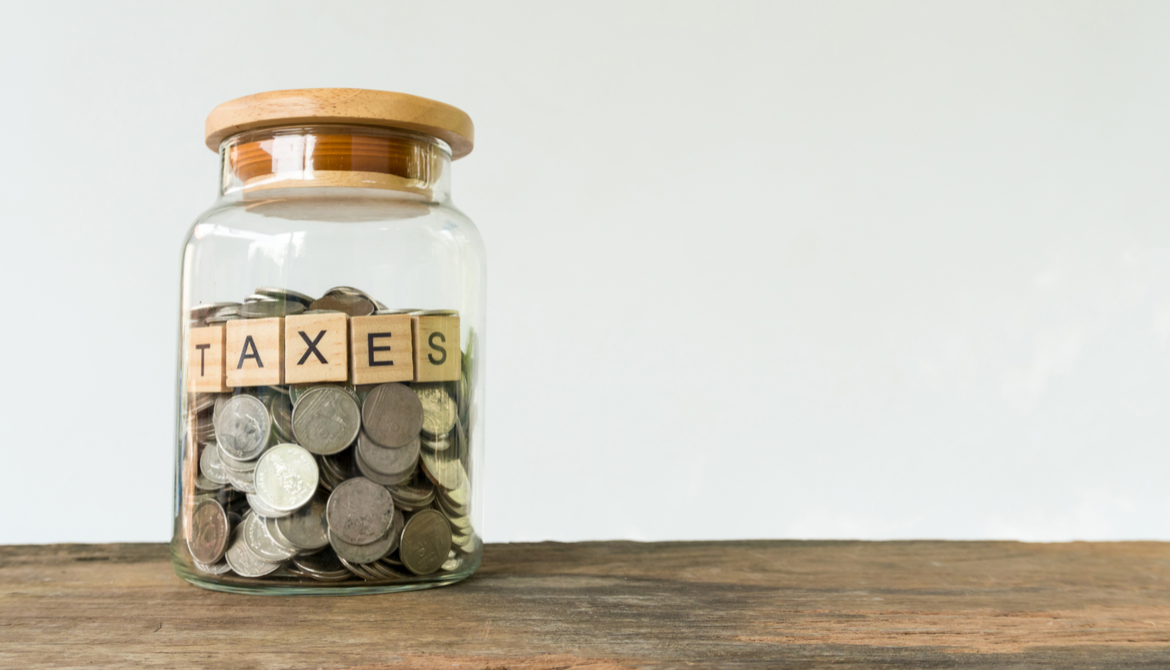 jar full of coins labeled taxes