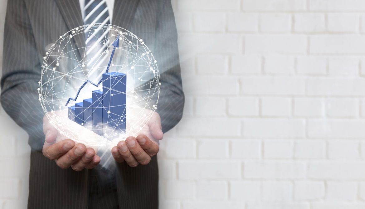 business man holding a glowing white orb with a bar graph inside of it