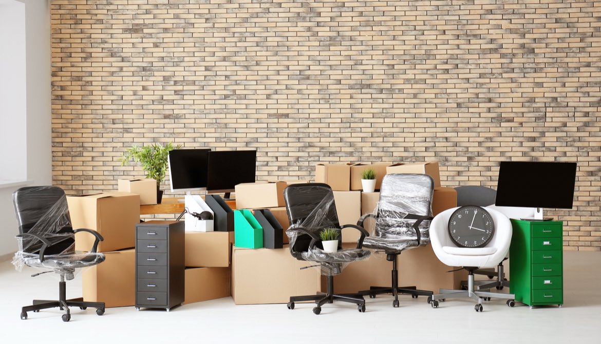 packed boxes and furniture in new office space