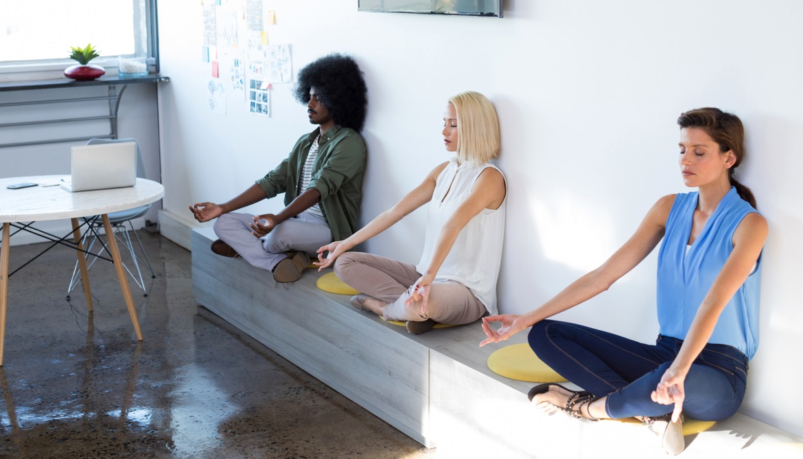 coworkers doing yoga at the office