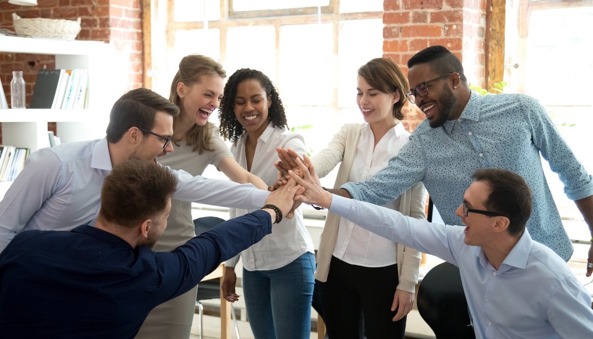 diverse and happy young team of business colleagues high five