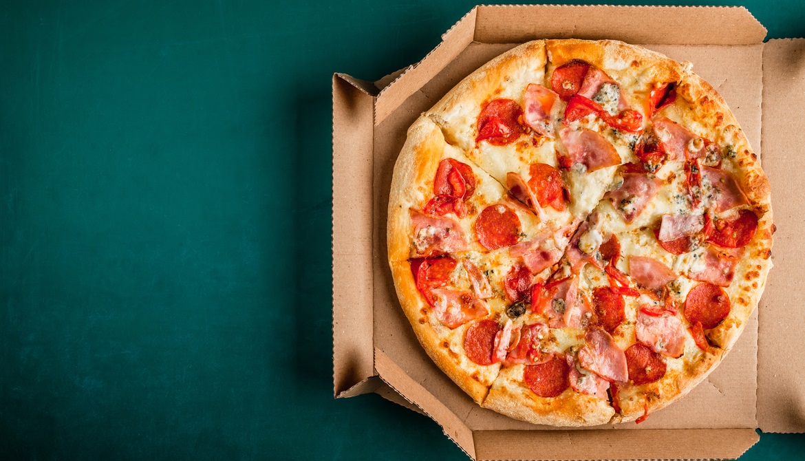 pizza in box on green background