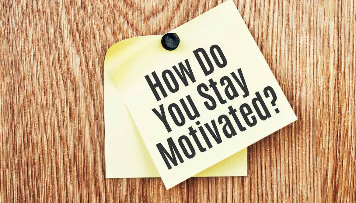 sticky note with a stay interview question asking how do you stay motivated