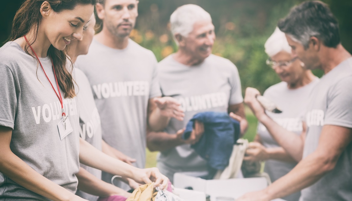 happy credit union volunteers at a community event