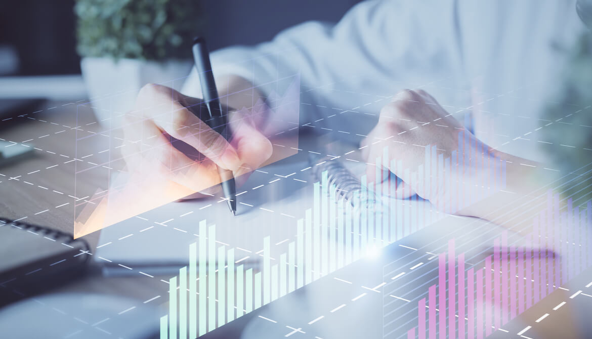 financial graph over a person working with a pencil