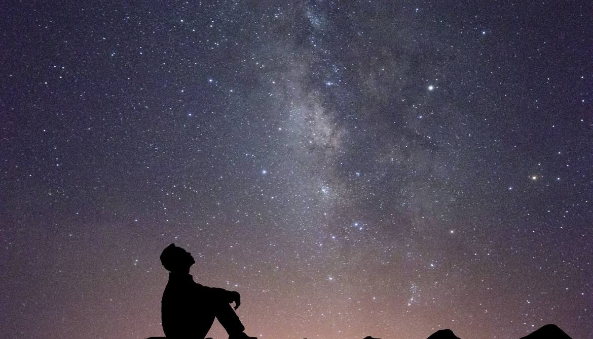 man looking at stars