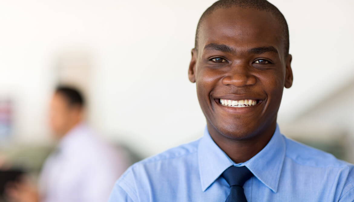 young black businessman smiling at camera