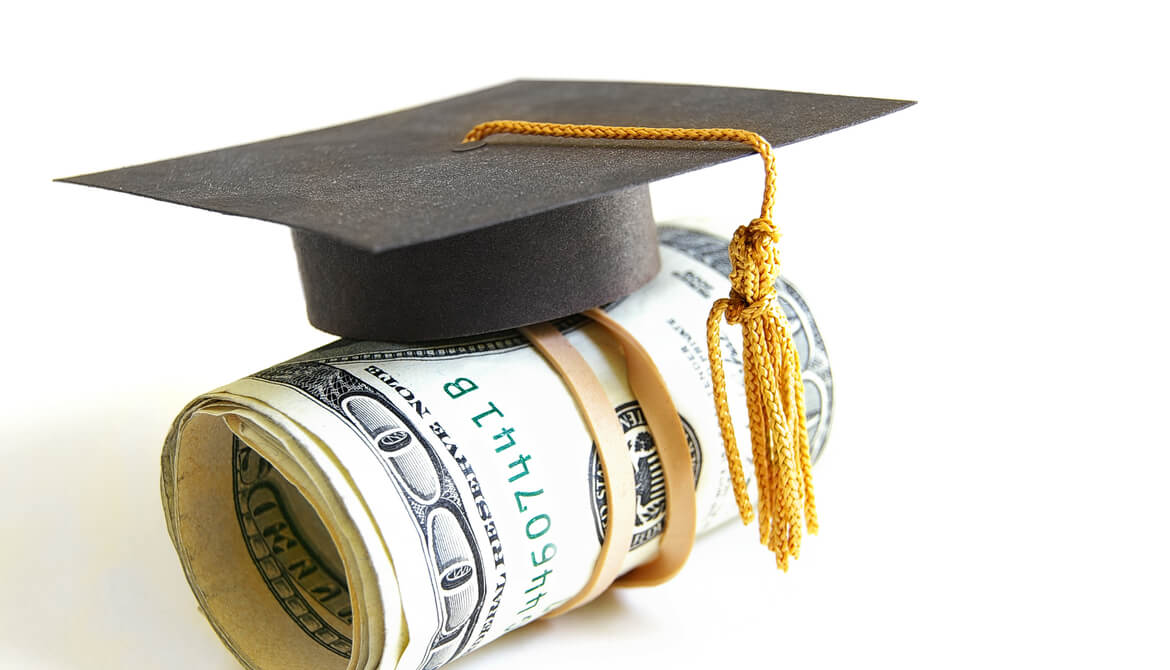 mini graduation cap on roll of money