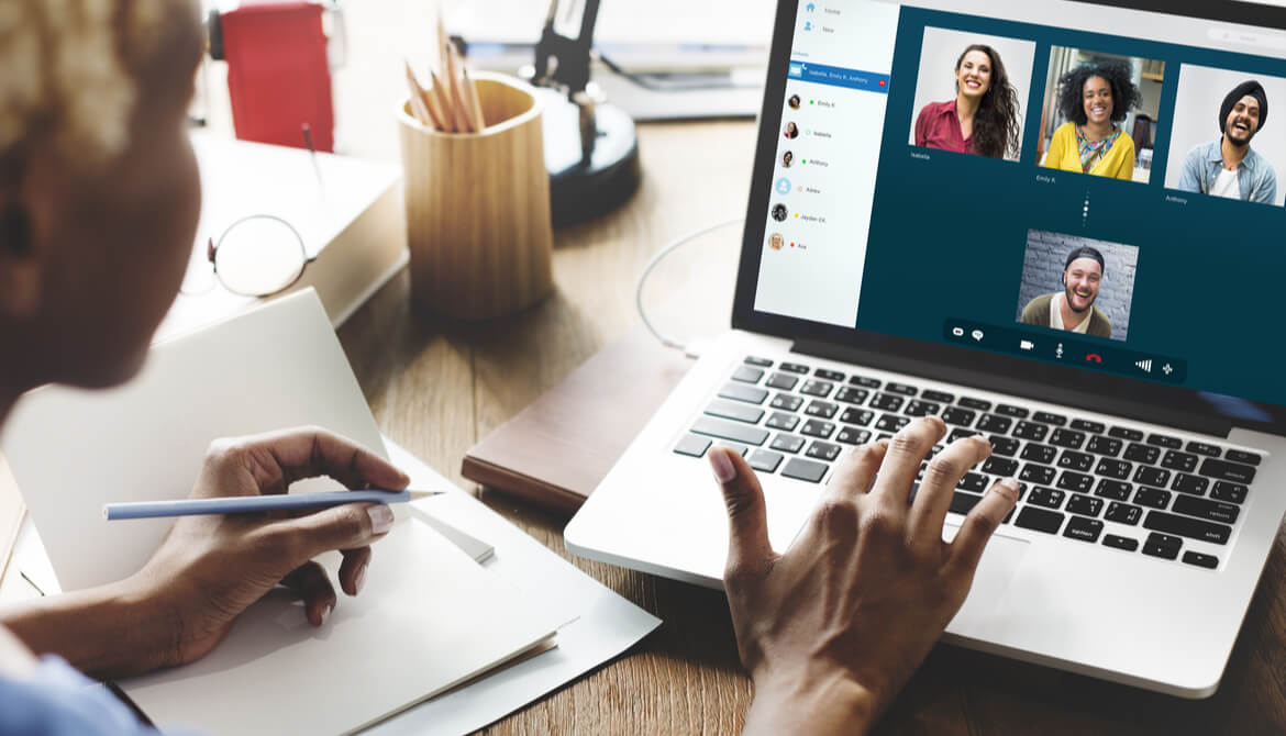 female African American business manager video chats with employee team on laptop