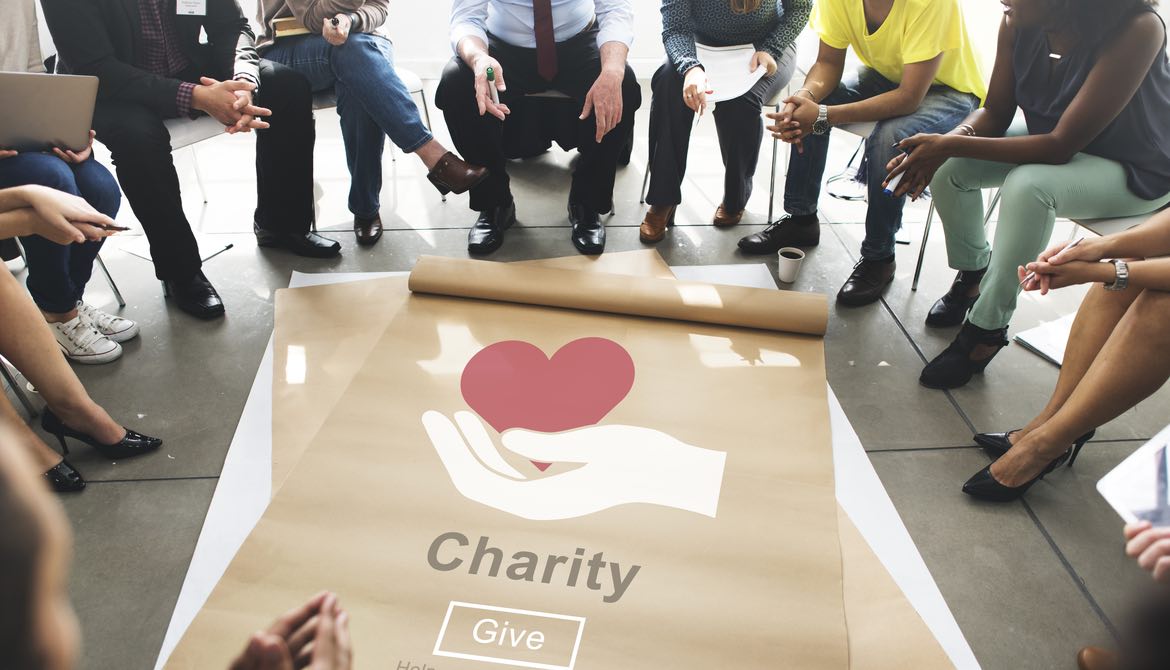 charity poster on floor with a work group