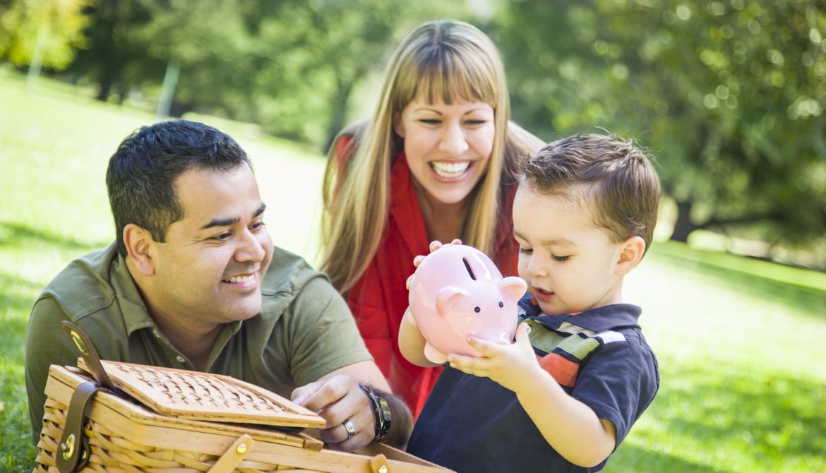 hispanic couple give their son a piggy bank
