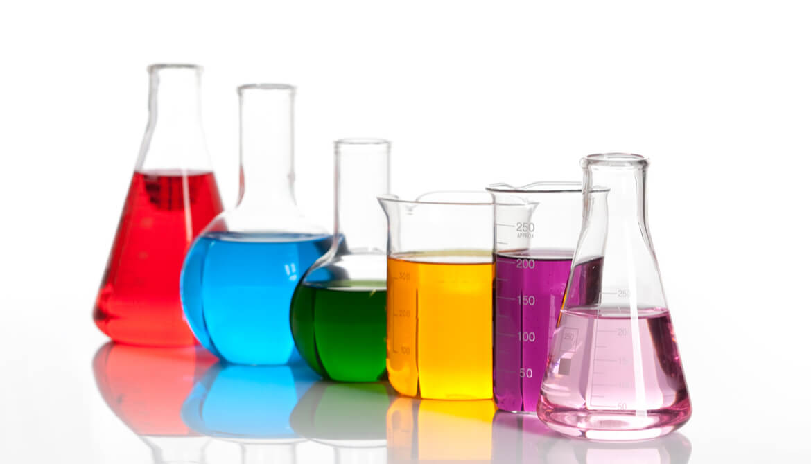 a variety of shaped lab beakers with different color liquid