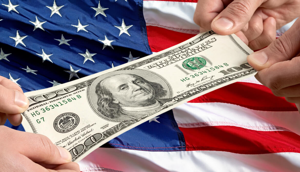 tug of war with 100 dollar bill and a US flag background