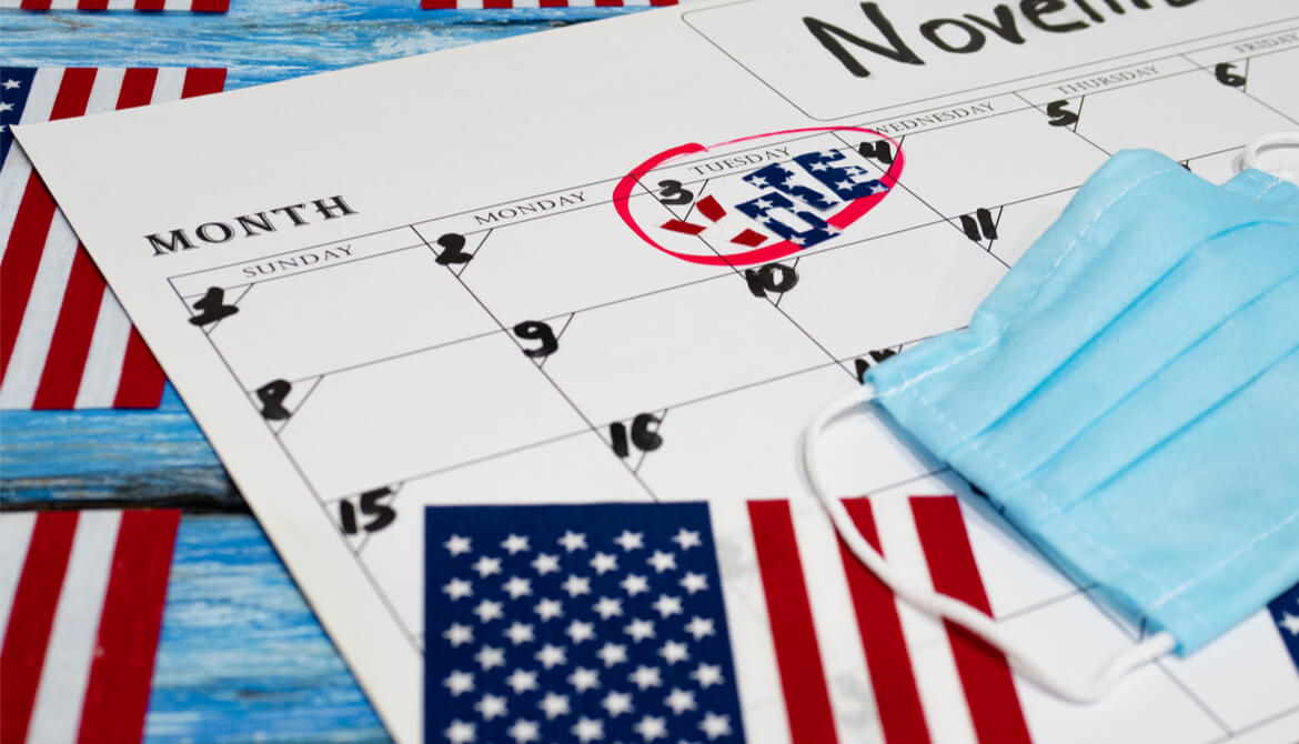 calendar with election day marked surrounded by U.S. flag and surgical mask