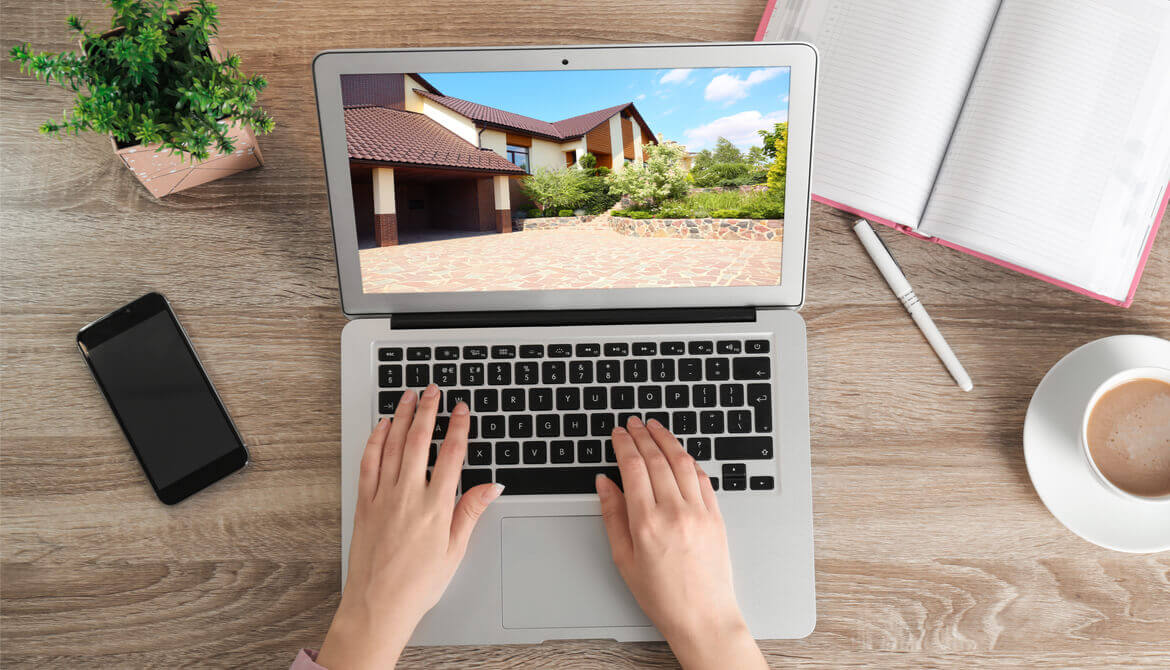 woman using laptop to shop for a home