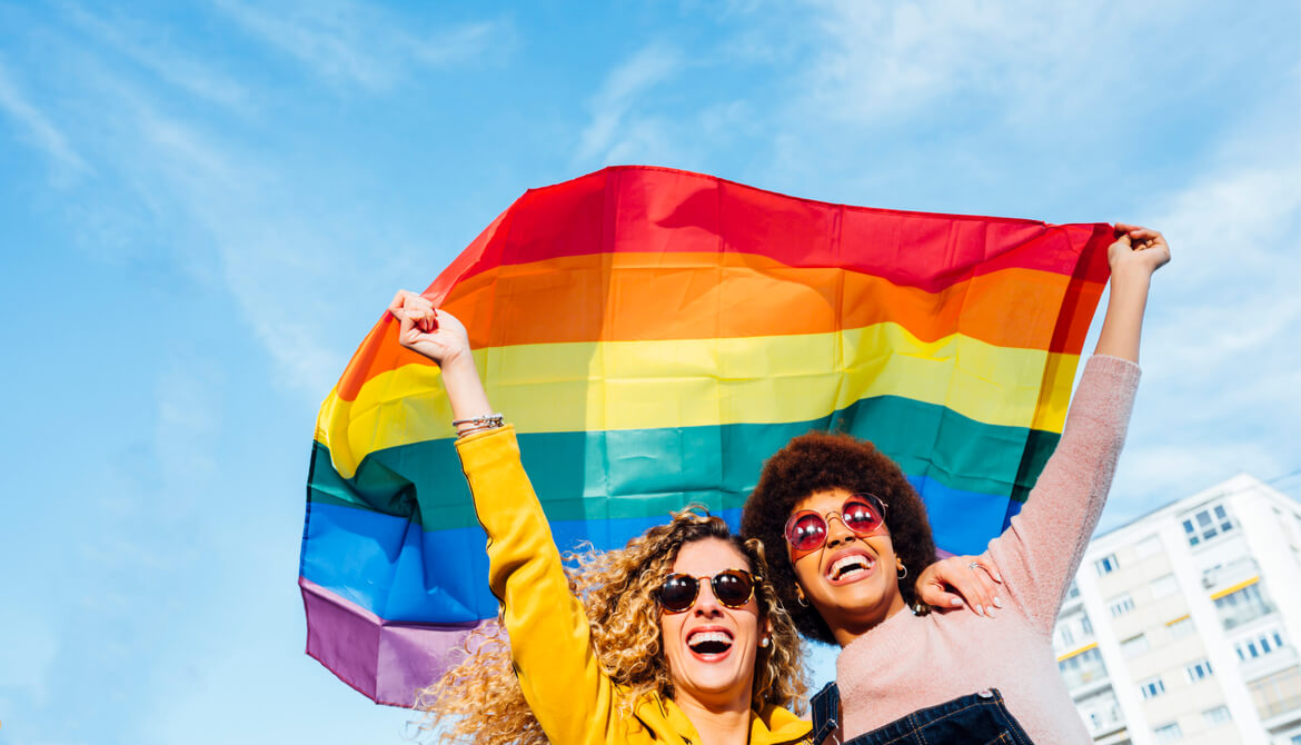 two women fly pride flag