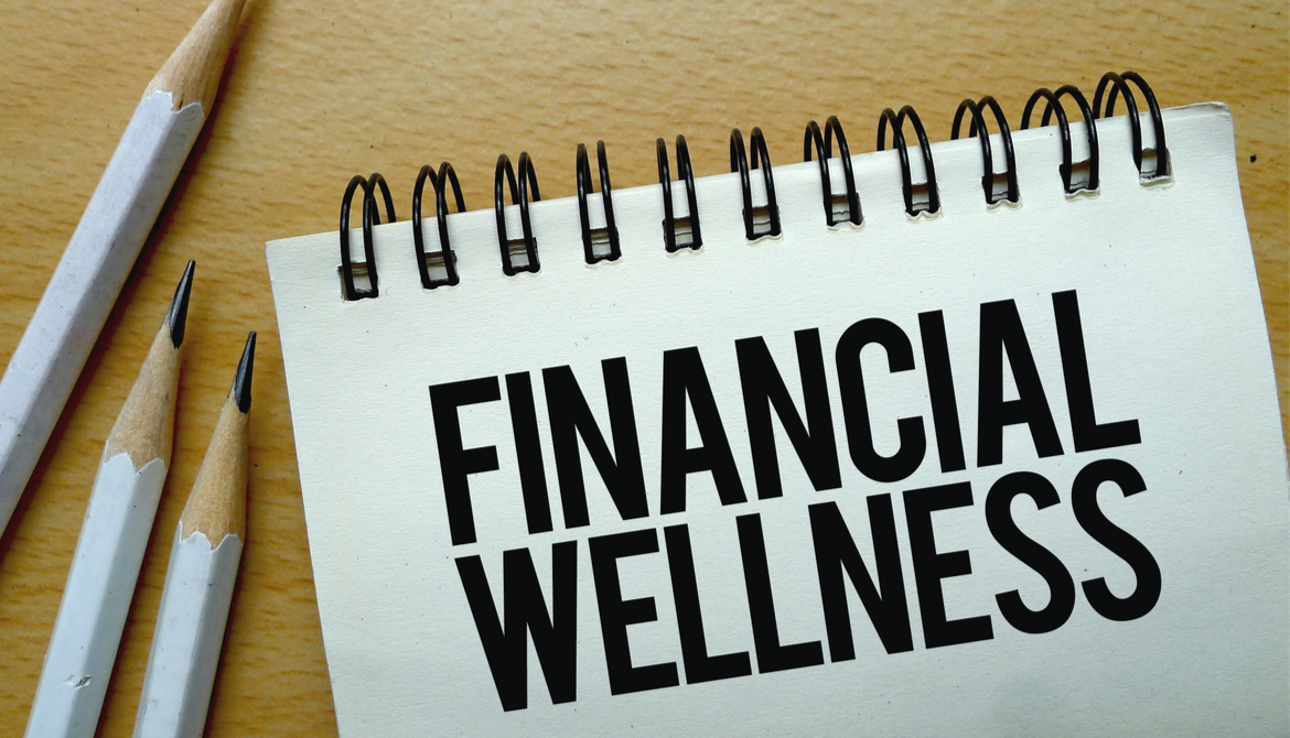 Financial Wellness text written on a notebook with pencils